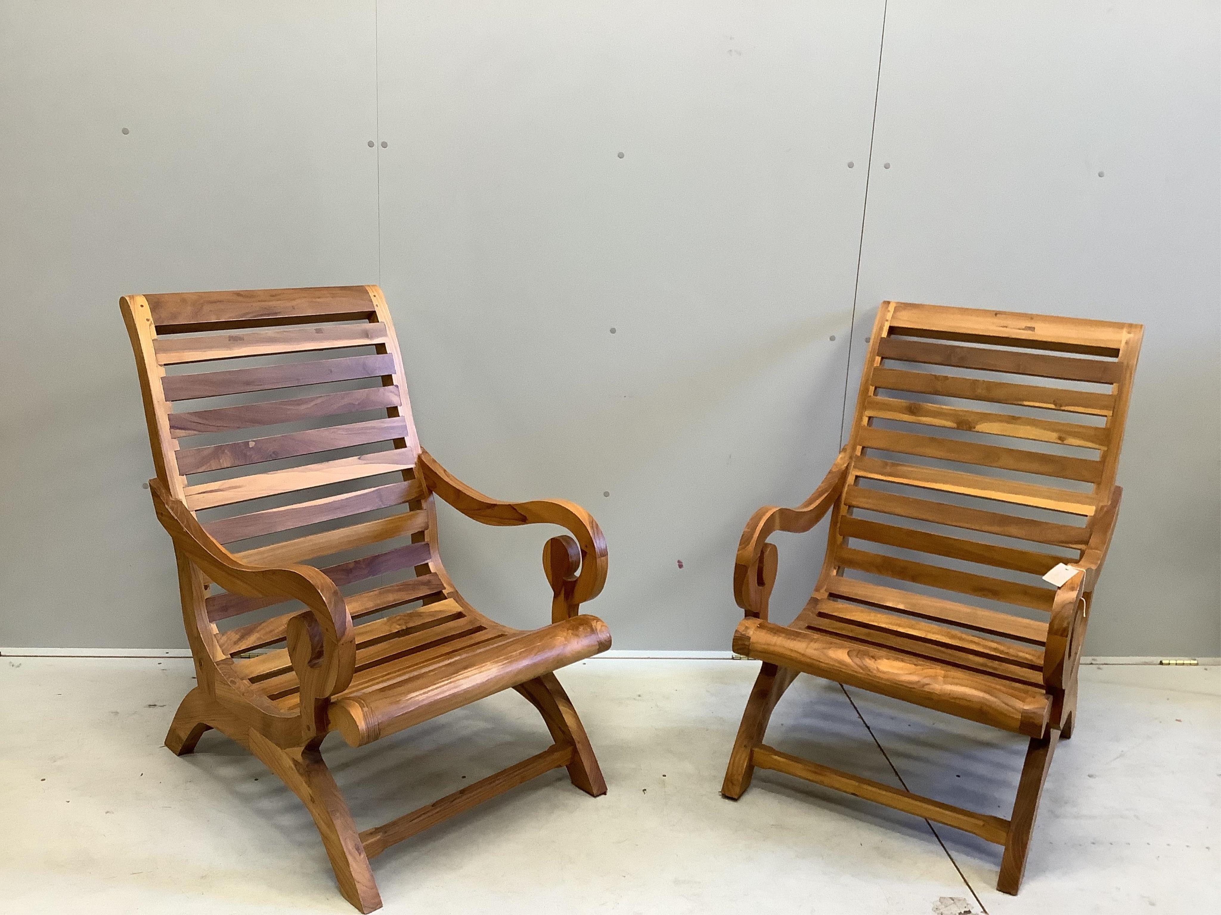 A pair of stained hardwood garden armchairs, width 64cm, depth 77cm, height 100cm. Condition - good